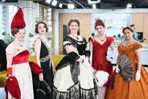 Pięć kobiet w strojach inspirowanych epoką, gotowych do poloneza. Każdy strój to dzieło sztuki, podkreślające elegancję tańca.